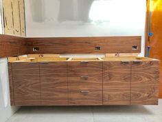 an unfinished kitchen with wooden cabinets and white walls