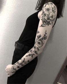 a woman with black and white flowers on her arm