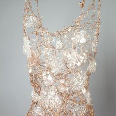 a dress made out of wire and beads