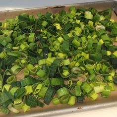 chopped green vegetables on a baking sheet ready to be cooked