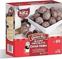 a box of chocolate donut holes sitting on top of a counter