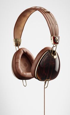 a pair of headphones sitting on top of a wooden stand in front of a white background