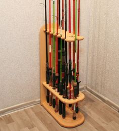 a rack that has many different types of fishing rods on it and is in front of a wall