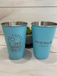 two blue cups sitting next to each other on a table