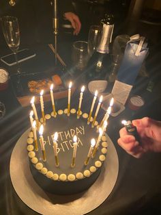 a birthday cake with lit candles on it