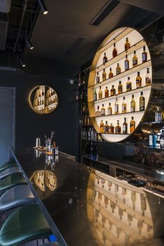 an empty bar with bottles on the shelves