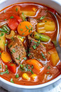 a white bowl filled with stew and vegetables