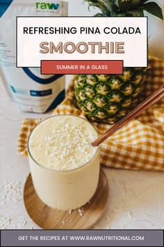 a smoothie in a glass next to a pineapple