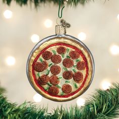 a pepperoni pizza ornament hanging from a christmas tree