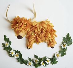 an animal made out of fake flowers and leaves