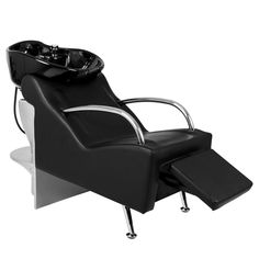 a black and white reclining chair sitting on top of a metal base with a foot rest