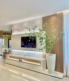 a living room filled with furniture and a large flat screen tv mounted on the wall