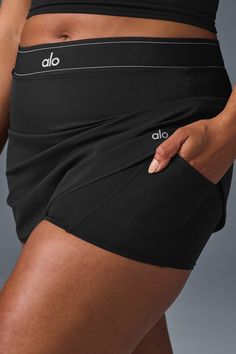 Take your look from the court to post-practice plans in the Match Point Tennis Skirt. It has a boxer-style elastic waistband (so on-trend), built-in shorts with a side pocket, and a mini-length hem. It’s made from a lightweight, slightly swishy performance fabric and has a cute, swingy fit. Wear it with a hoodie, a bra top, or even a blazer—this skirt aces the game every time. Sporty Swim Skirt With Built-in Shorts, Alo Yoga Athletic Shorts With Built-in Shorts For Workout, Sports Mini Skort With Elastic Waistband, Mini Skort For Sports With Elastic Waistband, Mini Skort With Elastic Waistband For Sports, Mini Skort With Built-in Shorts For Gym, Black Tennis Skirt With Built-in Shorts, Gym Activewear Mini Skirt With Built-in Shorts, Alo Yoga Athleisure Bottoms With Built-in Shorts