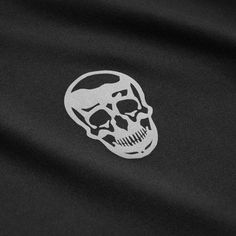 a white skull sticker is on the back of a black t - shirt,