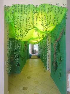 a hallway with green curtains and plants on the walls