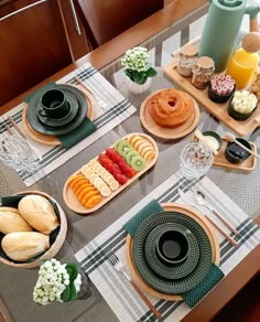 a table topped with plates and bowls filled with food