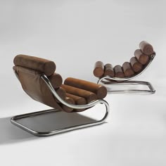 two lounge chairs with cigars on them and one chair is made out of wood