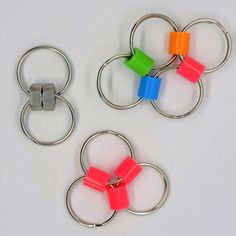 three key rings with different colored blocks on each one are attached to the same metal ring