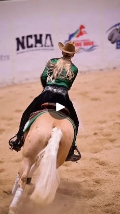 a woman riding on the back of a brown horse in an arena at a rodeo