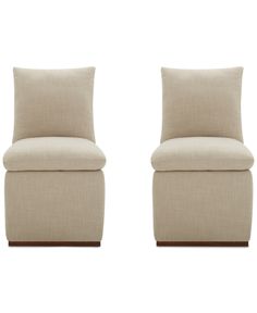 a pair of beige chairs sitting next to each other on top of a white floor