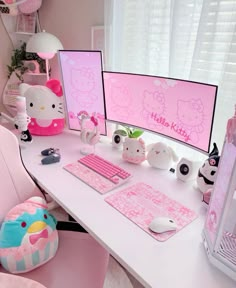 a white desk topped with two computer monitors next to a pink keyboard and mouse pad