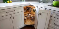 an open cabinet in the corner of a kitchen