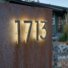 a house with a large number on the front and side of it that is lit up