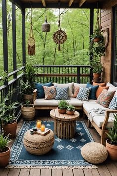 an outdoor living area with couches, tables and potted plants on the porch