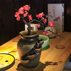 a vase filled with flowers sitting on top of a wooden table