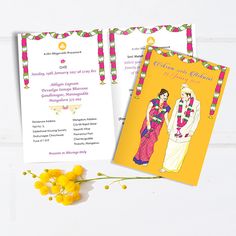 two wedding cards on a table with flowers