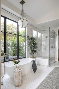 a bathroom with a large bathtub next to a walk in shower