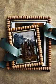 an old photo frame with a blue ribbon around it