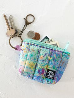 a small purse with keys and money in it