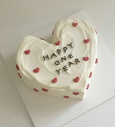 a heart - shaped cake with the words happy new year written in frosting on it