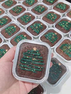 a person holding up a chocolate christmas tree