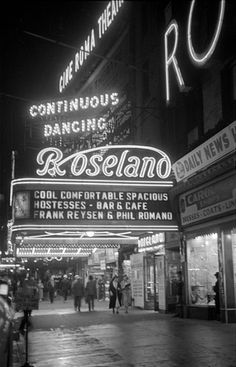 the neon sign for roseland is lit up at night in this black and white photo