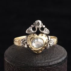 The Georgian period encompasses the reigns of the four King Georges from 1714 to 1830. During this time, the aristocracy made it a point to flaunt their wealth by making sure they were absolutely dripping with jewels at all times. Although engagement rings were uncommon - they weren't frequently given until the Victorian era - the exception to this rule was the crowned heart ring. These rare pieces would be given to one's betrothed as a token of love and devotion. This c. 1780 crowned heart ring Pearl Cluster Ring, Film Ideas, Wax Seal Necklace, Diamond Star Necklace, Locket Ring, Diamond Crown, Bow Bracelet, Tiny Diamond, Diamond Star