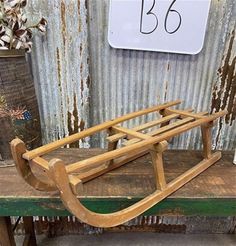 a wooden sled sitting on top of a green table