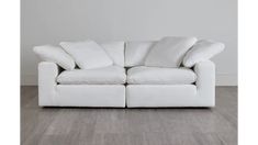 a white couch sitting on top of a hard wood floor