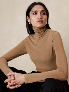 A classic turtleneck made in our new wool blend jersey, selected for its lightweight warmth and buttery handfeel.  Stretches to fit.  Turtleneck.  Stretches to fit.  Long sleeves.  Hip length.  Model: Size S, 5'10" (178cm). Turtleneck And Tshirt, Womens Tank Tops Summer, Classic Turtleneck, Turtleneck Jumper, Business Skirt, Turtleneck T Shirt, Orange Ombre, Turtle Neck Jumper, Fitted Turtleneck