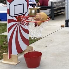 an inflatable basketball hoop and bucket on the sidewalk