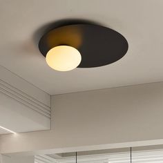 a round light fixture is mounted on the ceiling