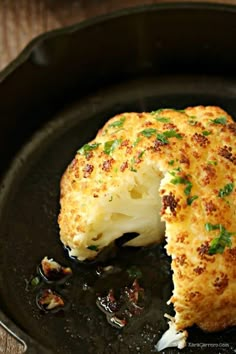 a close up of a piece of food in a pan with broccoli on it