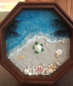 an ocean scene made out of sand and shells