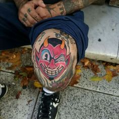 a man with tattoos on his leg and knee