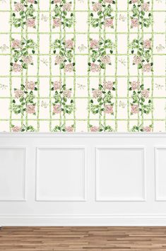 the wallpaper in this room is decorated with pink flowers and green bamboo sticks, which are