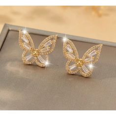 These Exquisite Gold Butterfly Stud Earrings Are Adorned With Sparkling Rhinestones, Offering A Sophisticated Touch To Any Outfit. Perfect For Special Events And As A Thoughtful Gift. Gold-Plated Metal Crystal Rhinestone Inlay Butterfly Shape Sparkling Finish Stud Closure Lightweight Design 0.748 In X 0.669 In Butterfly Cubic Zirconia Wedding Earrings, Wedding Butterfly Cubic Zirconia Earrings, Gold Cubic Zirconia Butterfly Earrings, Gold Rhinestone Earrings For Gift, Gold Butterfly Earrings For Party, Gold Earrings With Rhinestones For Gift, Gold Crystal Earrings With Rhinestones Gift, Gold Crystal Earrings With Rhinestones, Butterfly Shaped Earrings With Diamond Accents