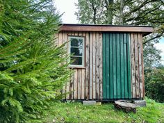 a small wooden building sitting in the middle of a forest