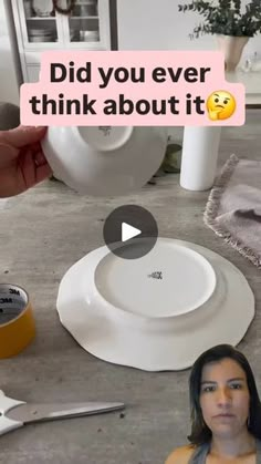 a woman sitting in front of a white plate on top of a table next to other plates