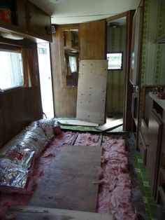 the inside of a house being remodeled with wood flooring and carpeted area in front of it